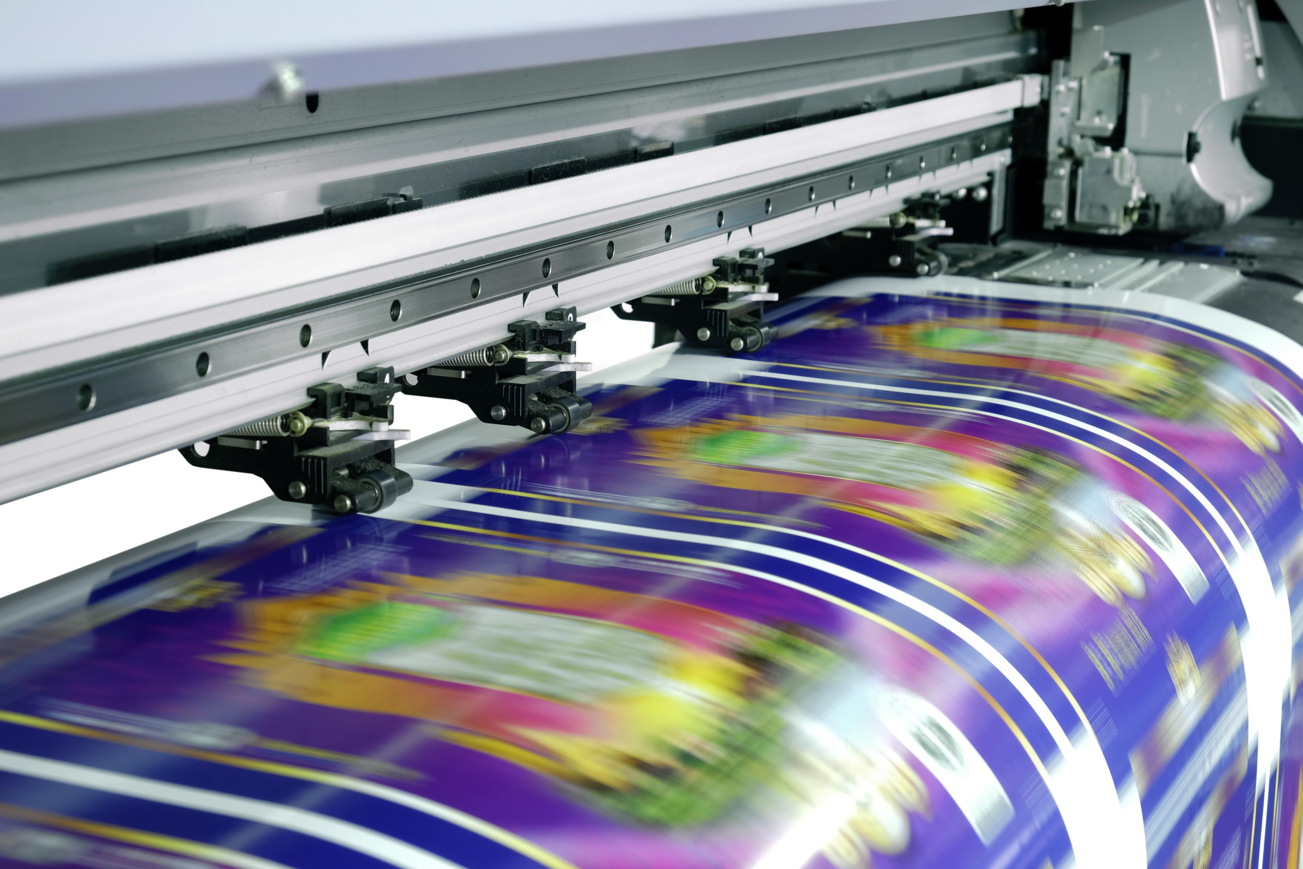 Custom digitally printed Mylar packaging bags with multiple designs and industrial digital printing equipment.
